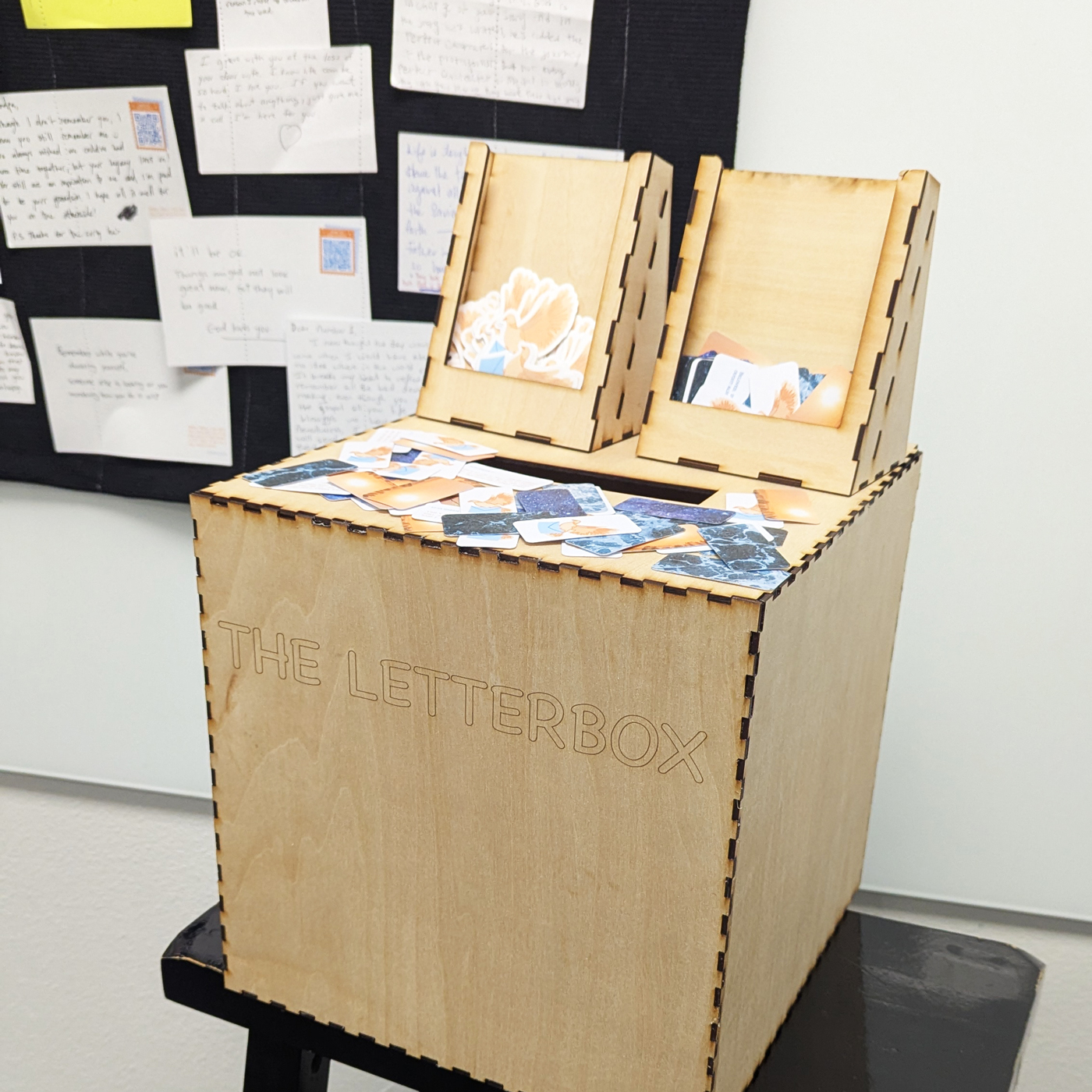 a photograph of the letter box and a board with anonymous letters